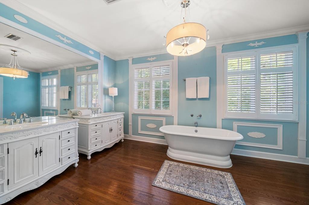 1102 Palmview Avenue Belleair, FL 33756 - Photo 33 of 81 a spacious bathroom with double vanity a mirror a bathtub and a window