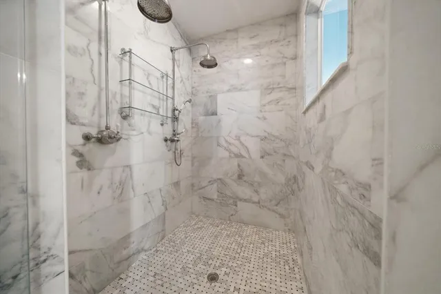 a view of a house with pool fire pit and chairs in a patio
