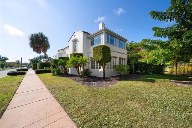 a front view of a house with yard and green space