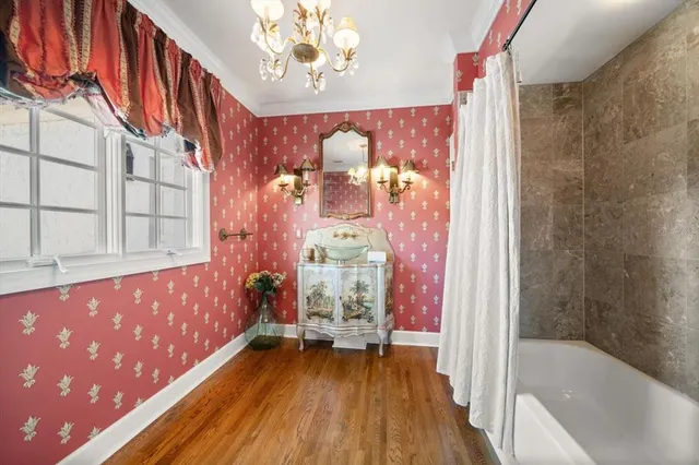 a front view of a house with a yard and potted plants