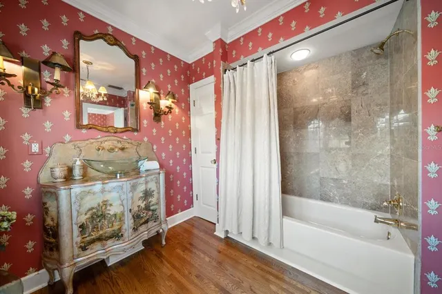 an aerial view of ocean and residential houses with outdoor space