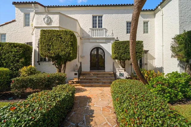 a room with furniture a fireplace and a chandelier