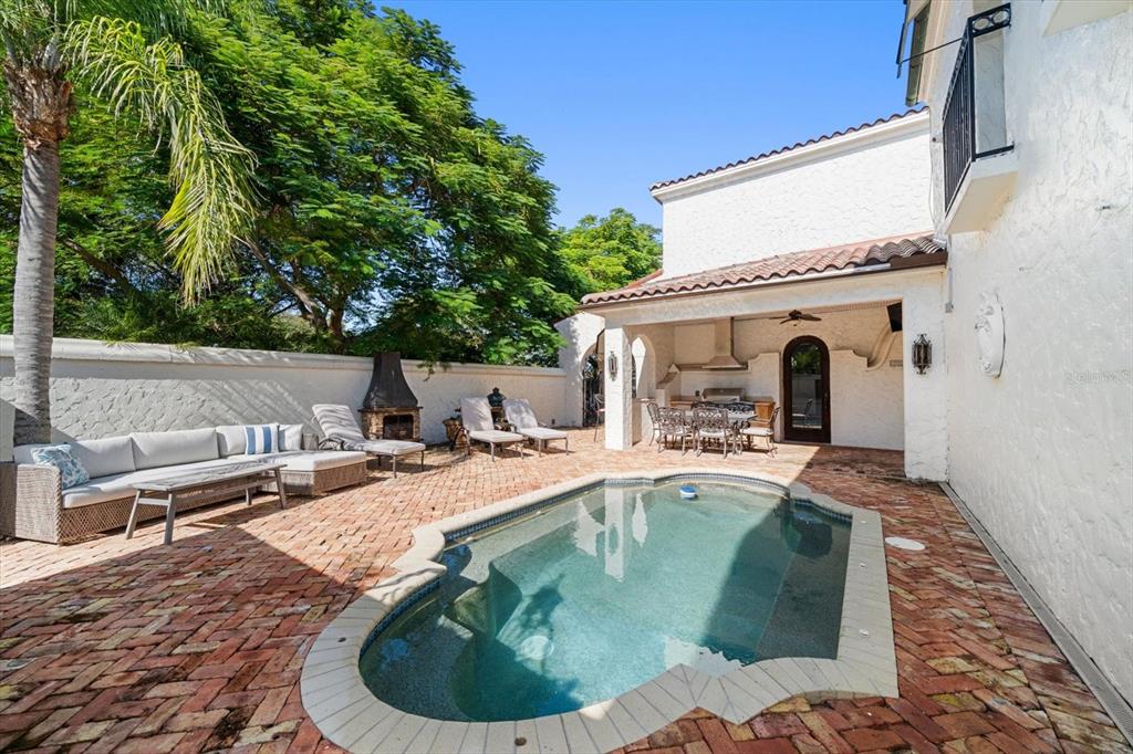 1102 Palmview Avenue Belleair, FL 33756 - Photo 54 of 81 a view of a house with pool fire pit and chairs in a patio