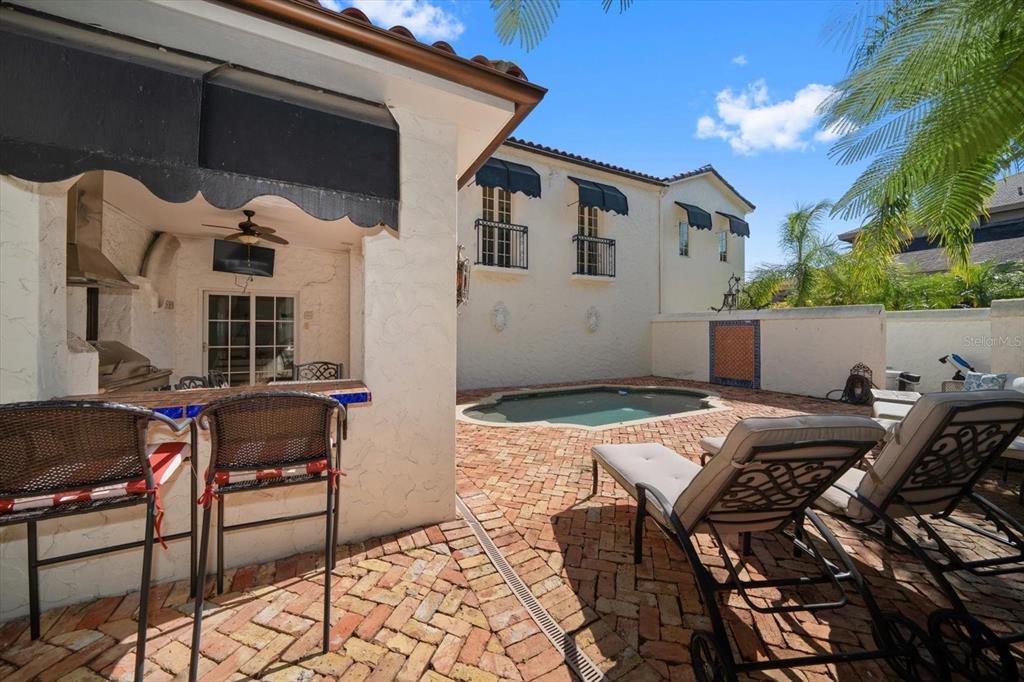 1102 Palmview Avenue Belleair, FL 33756 - Photo 56 of 81 a view of a patio with table and chairs and potted plants
