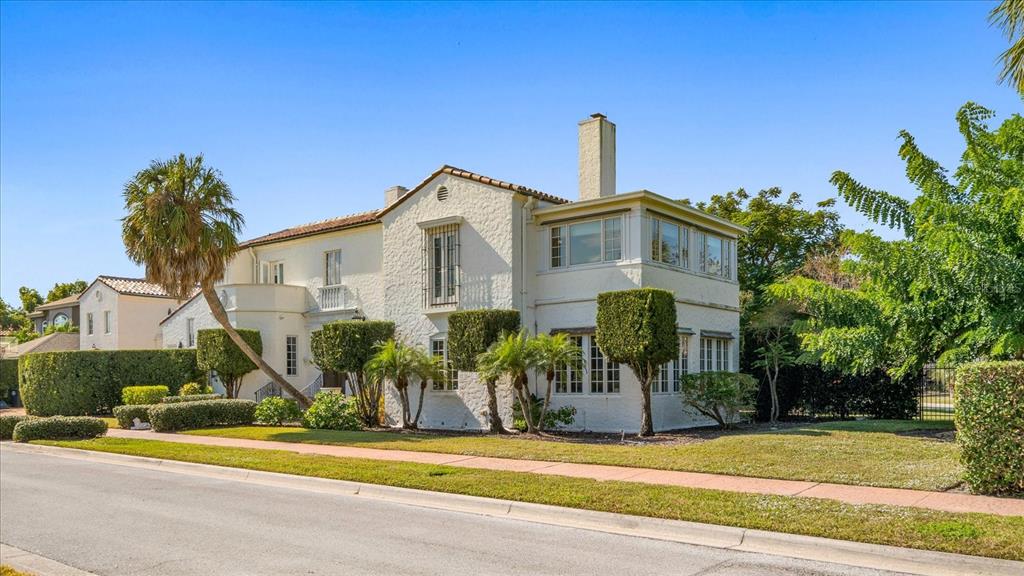 1102 Palmview Avenue Belleair, FL 33756 - Photo 75 of 81 a front view of a house with a yard and potted plants