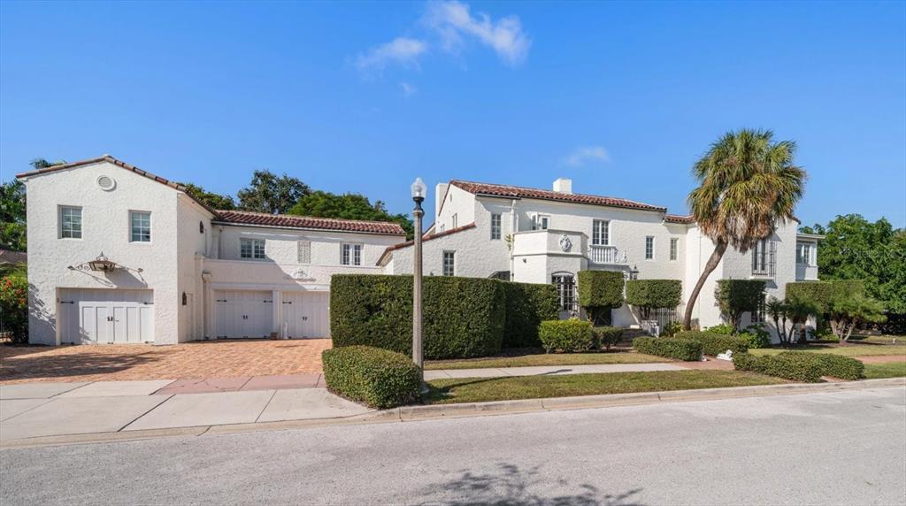 1102 Palmview Avenue Belleair, FL 33756 - Photo 79 of 81 a front view of a house with a yard and garage