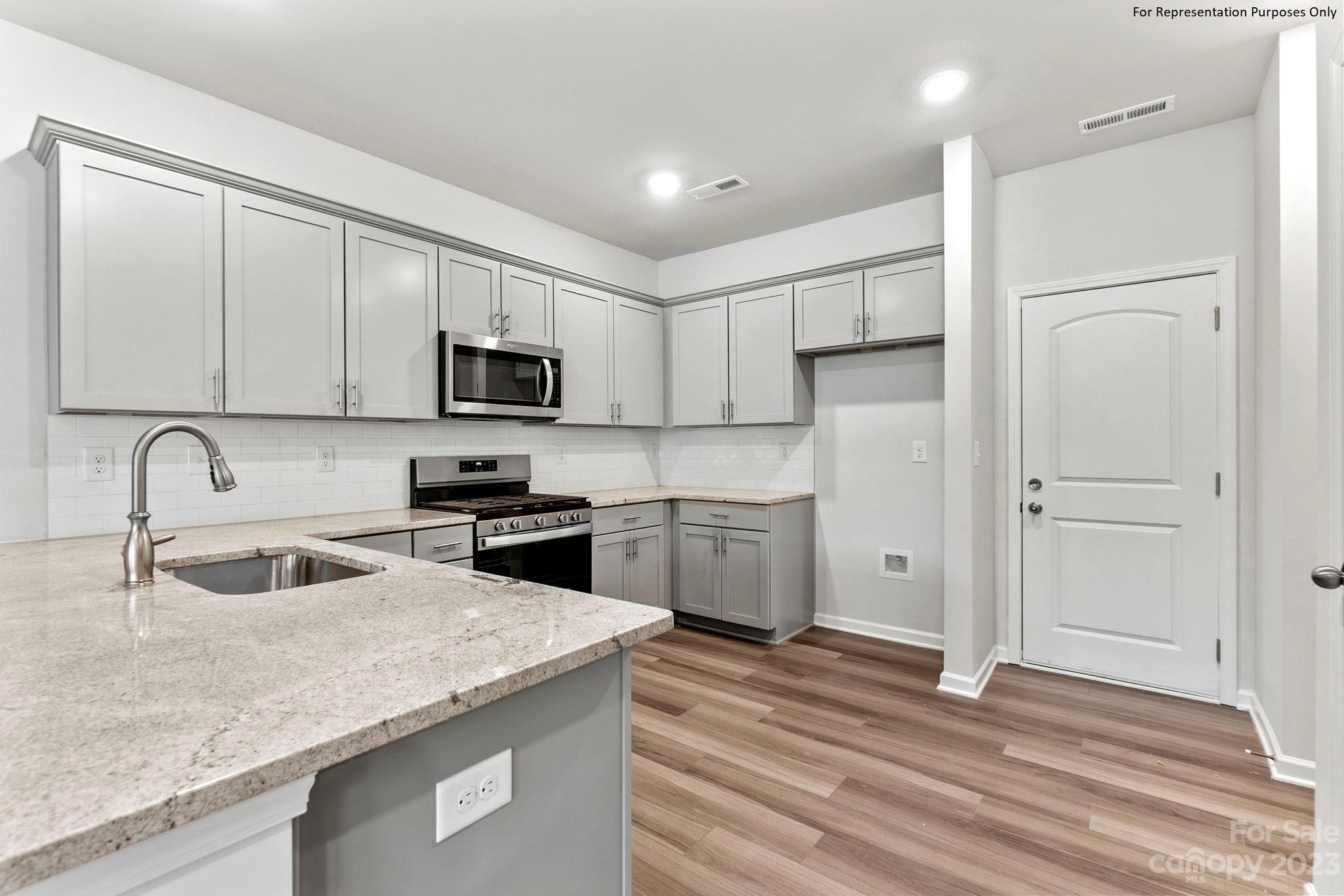 1948 Plath Top Road, Unit 24 Rock Hill, SC 29732 - Photo 11 of 44 a kitchen with granite countertop white cabinets and stainless steel appliances