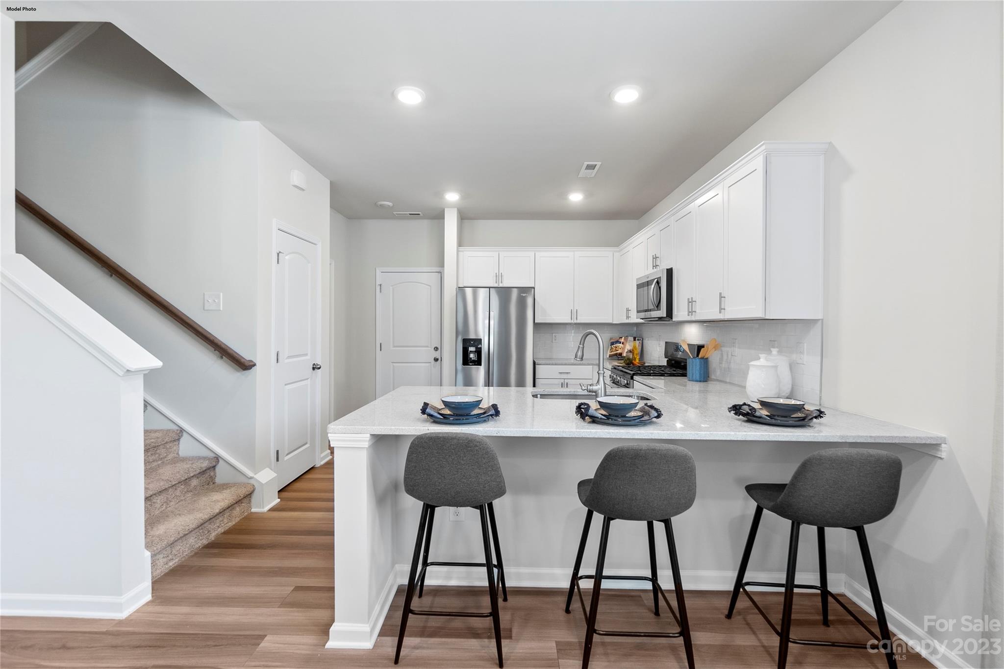 1948 Plath Top Road, Unit 24 Rock Hill, SC 29732 - Photo 28 of 44 a kitchen with stainless steel appliances kitchen island granite countertop a dining table chairs and granite counter tops