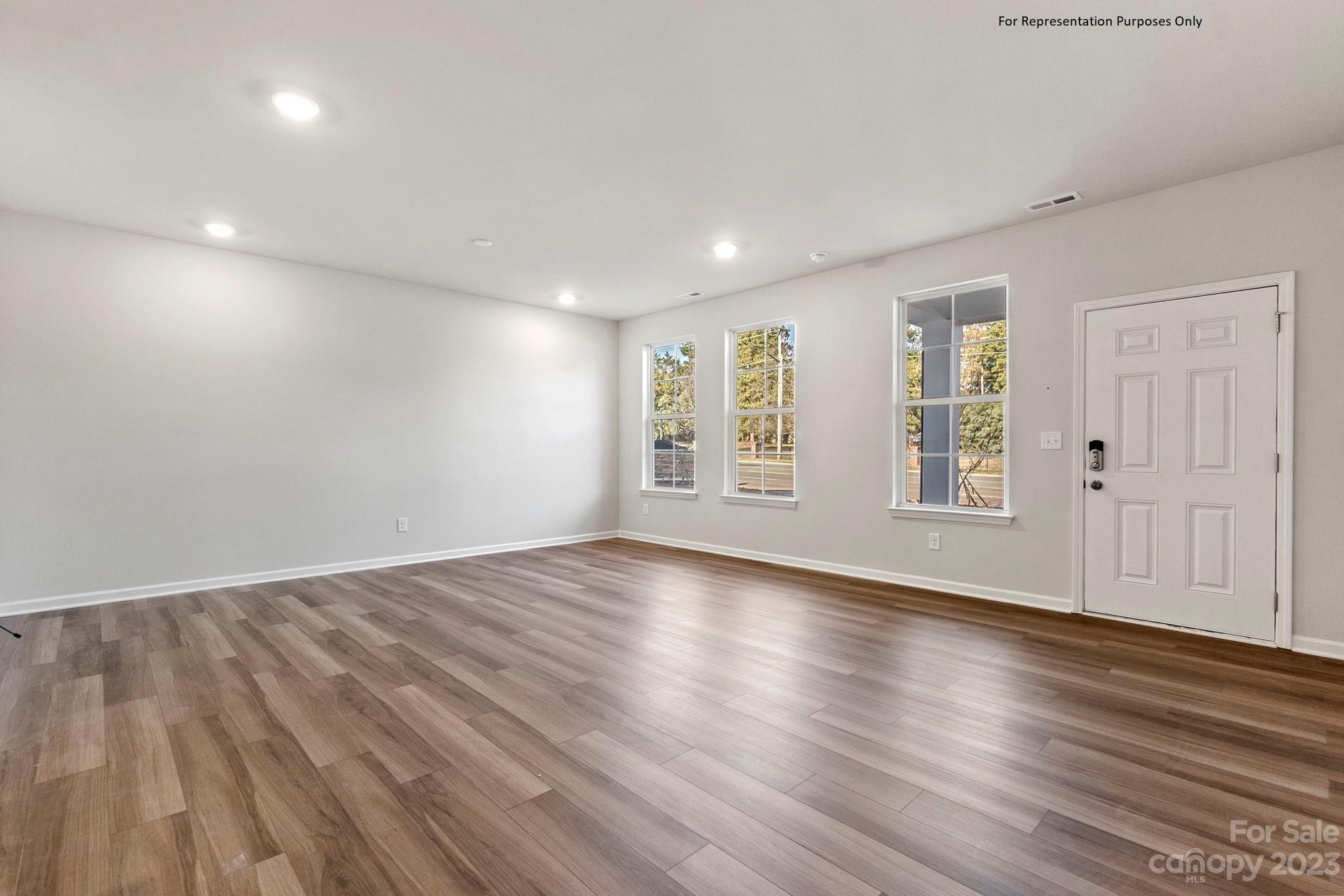 1948 Plath Top Road, Unit 24 Rock Hill, SC 29732 - Photo 7 of 44 an empty room with wooden floor and windows