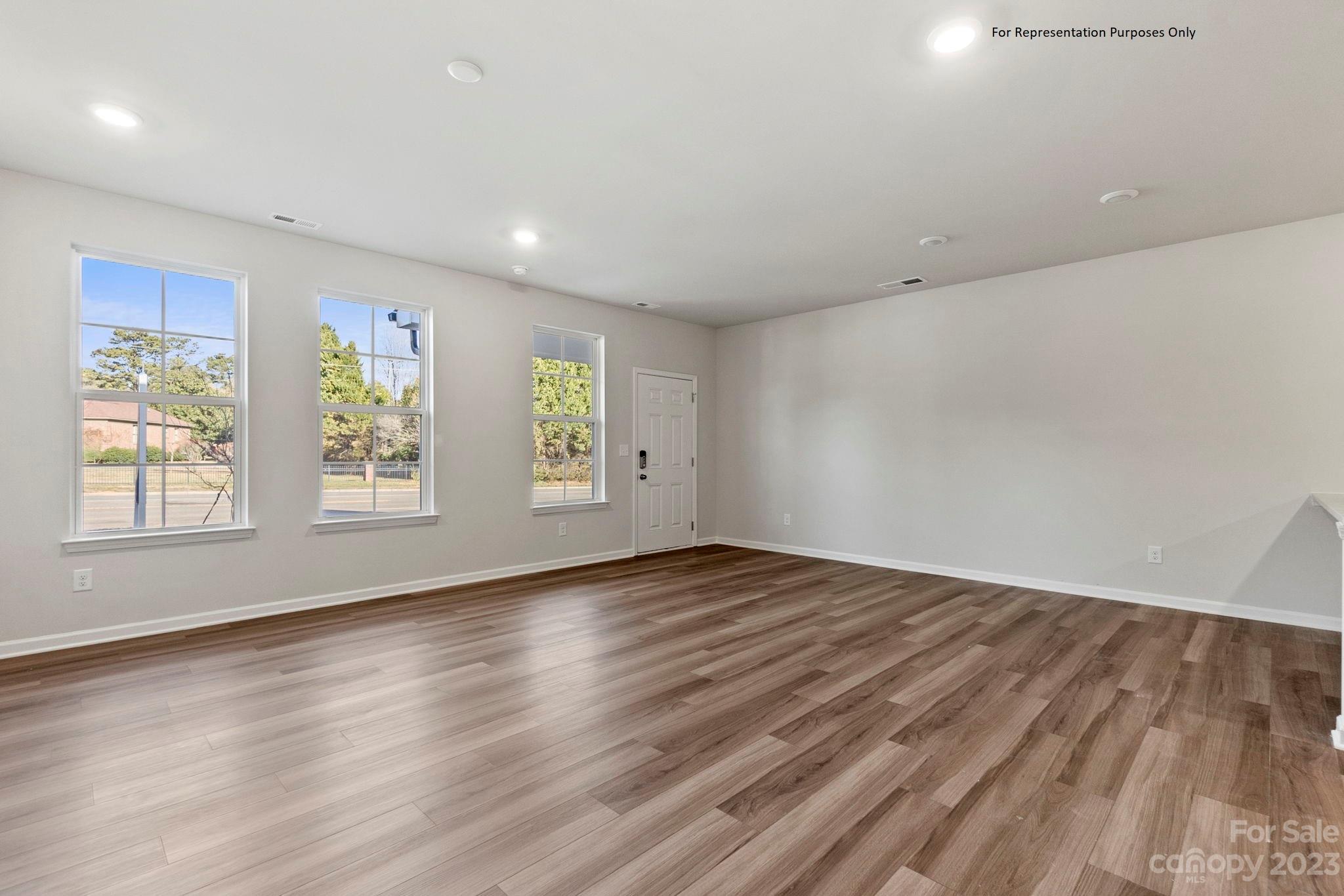 1948 Plath Top Road, Unit 24 Rock Hill, SC 29732 - Photo 8 of 44 an empty room with wooden floor and windows