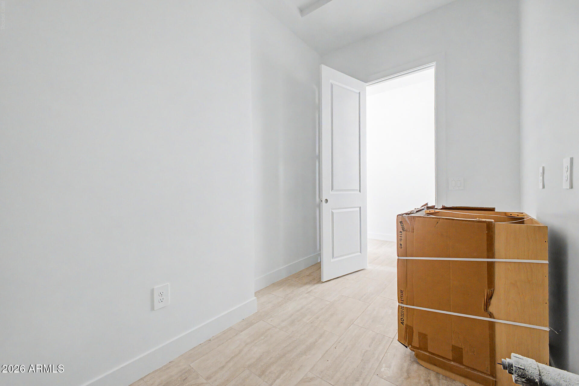 18815 West Arlington Road Buckeye, AZ 85326 - Photo 45 of 56 a room with a door and a wooden floor