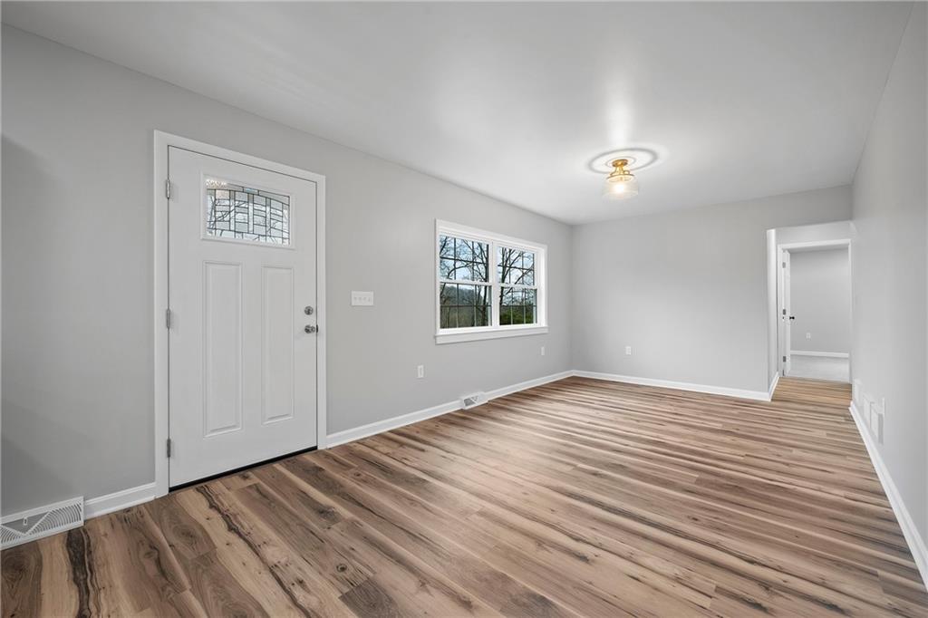 6340 Old Rte 8 North Butler, PA 16002 - Photo 6 of 33 a view of an empty room with wooden floor and a window