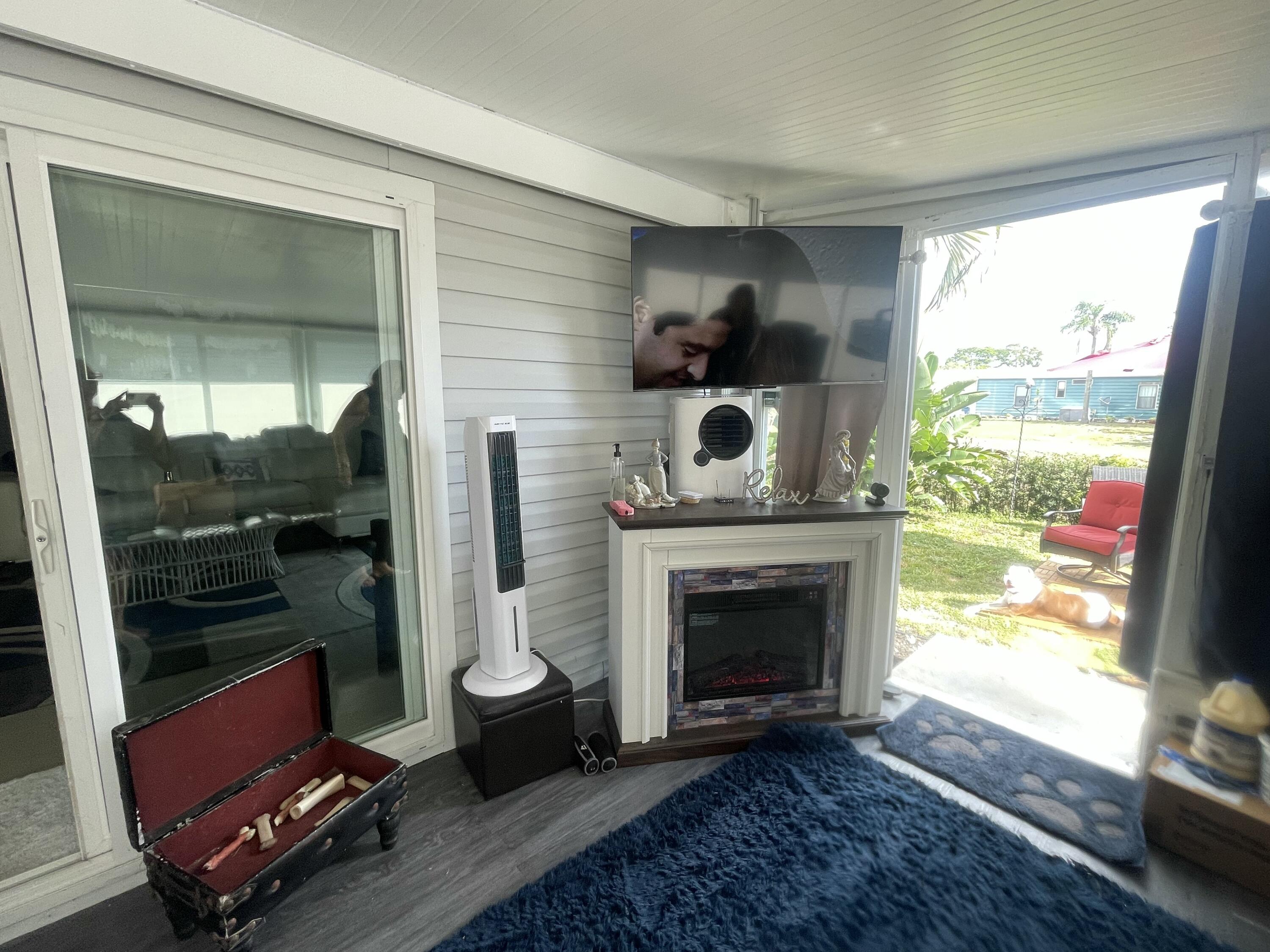 817 Sunglow Street Boynton Beach, FL 33436 - Photo 12 of 15 a living room with furniture and a fireplace