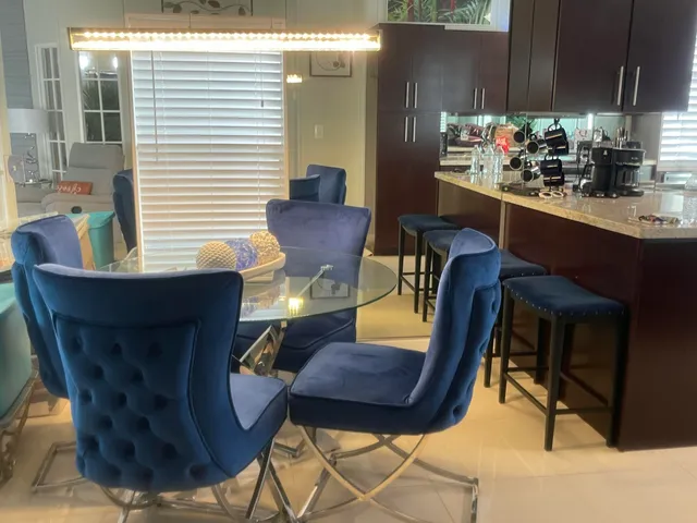 a view of a dining room with furniture and chandelier