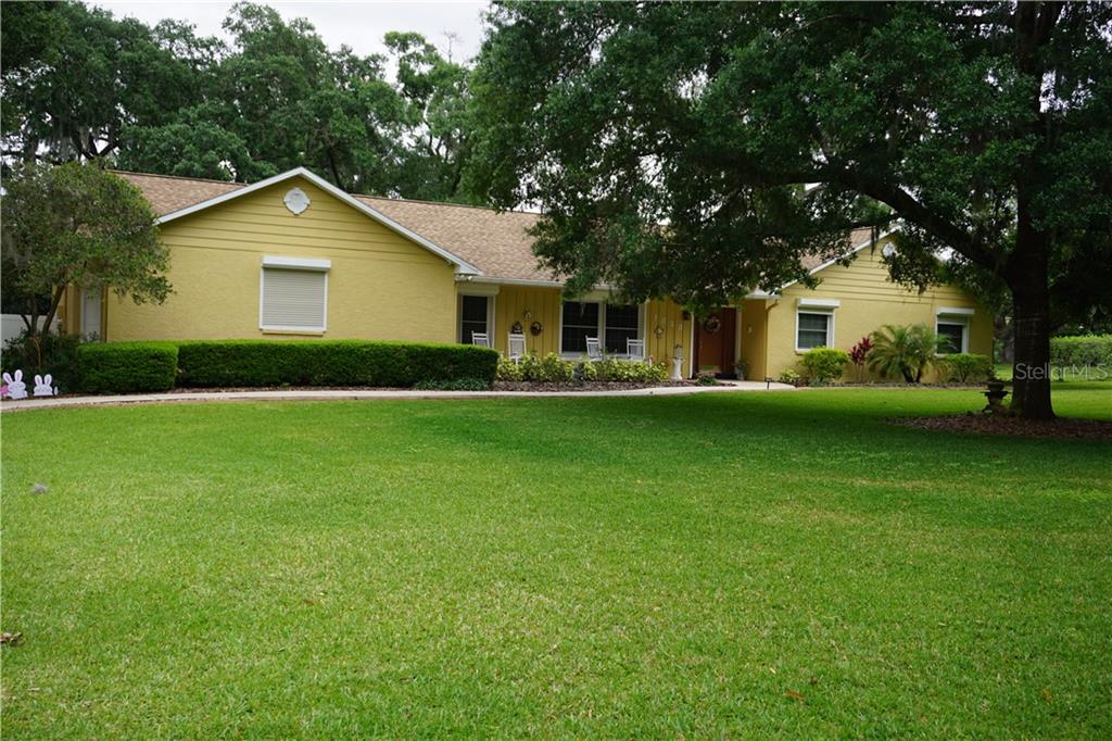1823 South Valrico Road Valrico, FL 33596 - Photo 41 of 49 You can see in this front yard picture the Hurricane Shutter is down. All the windows have them!