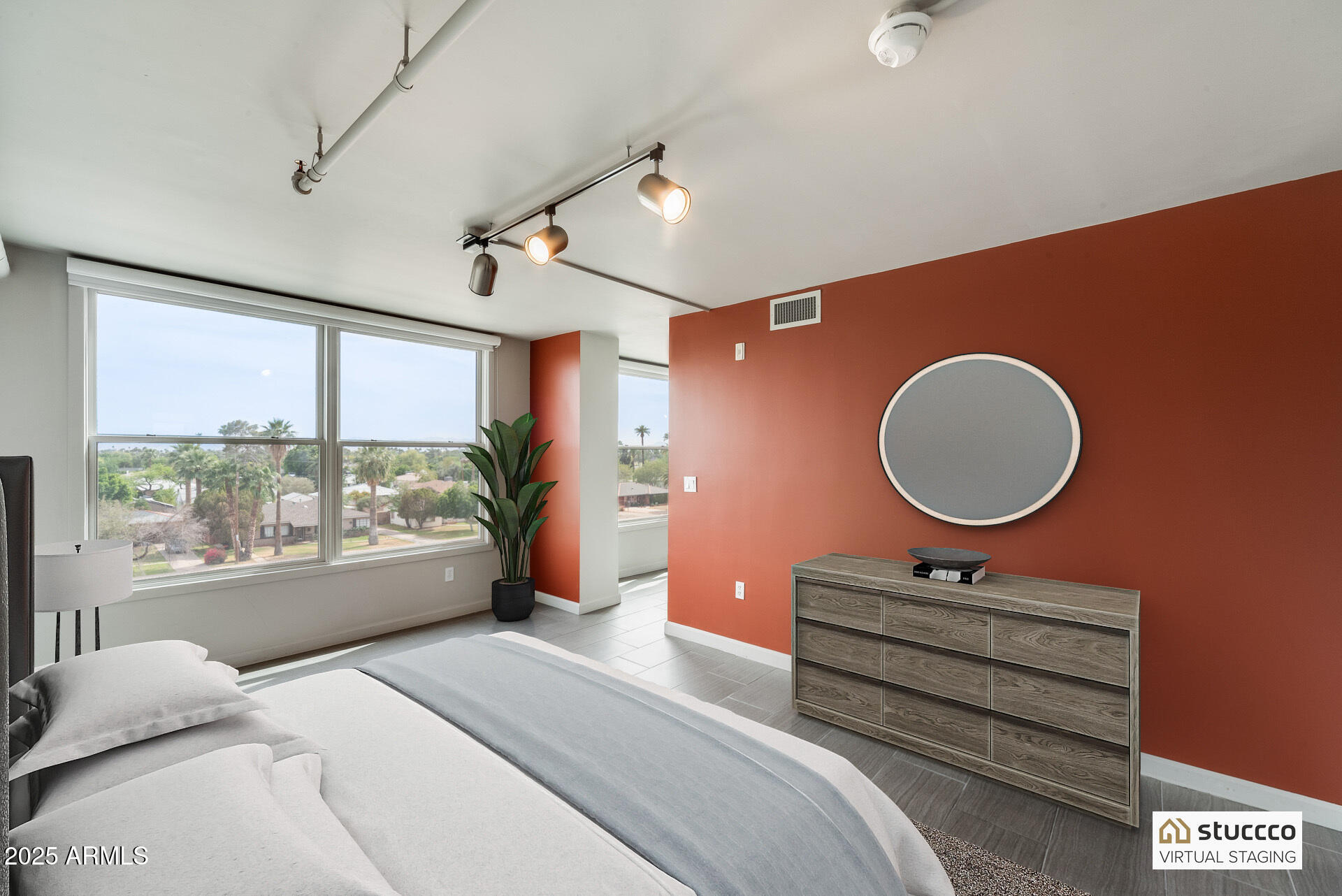 535 West Thomas Road, Unit 410 Phoenix, AZ 85013 - Photo 5 of 33 a bedroom with a bed a mirror and a large window