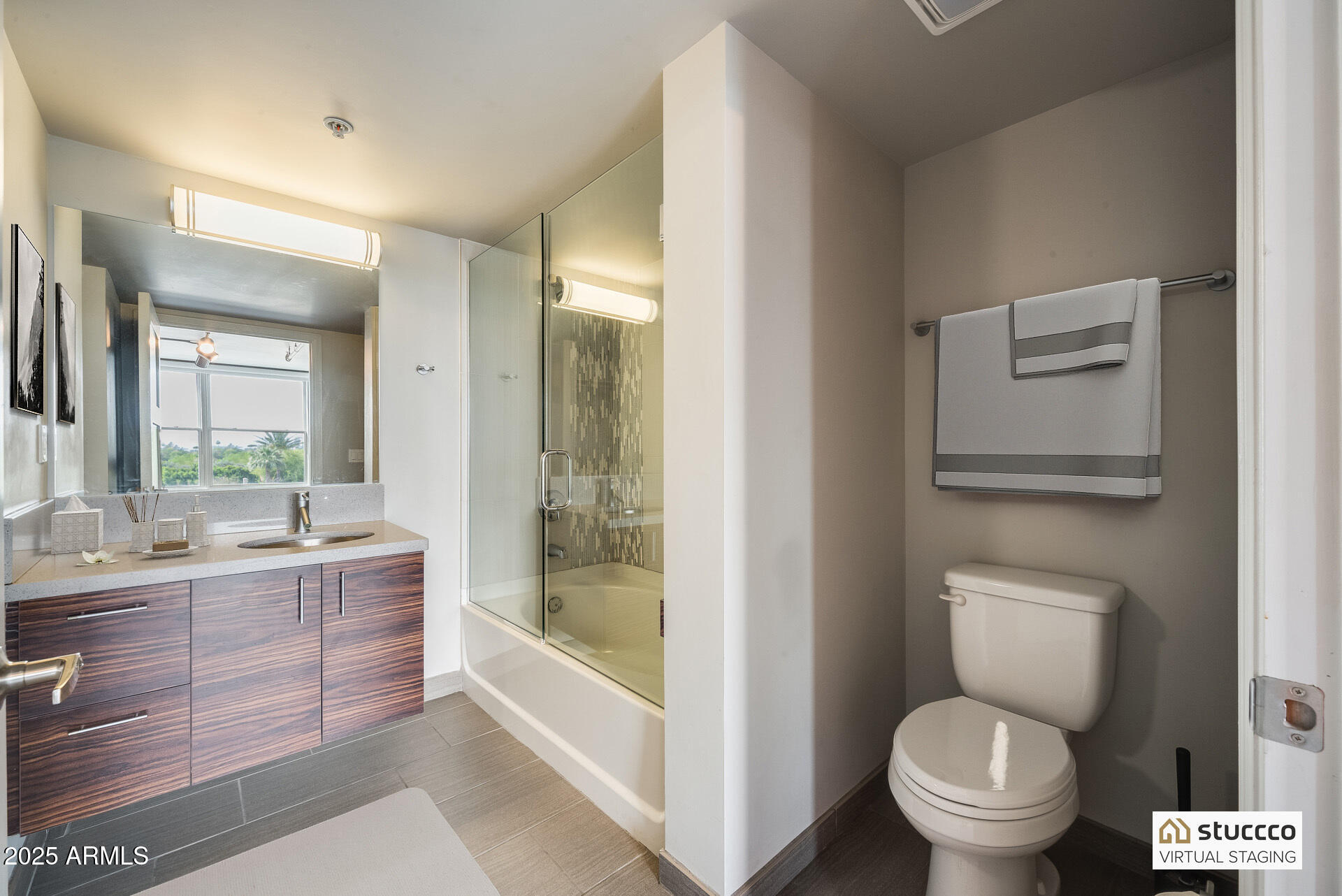 535 West Thomas Road, Unit 410 Phoenix, AZ 85013 - Photo 6 of 33 a bathroom with a granite countertop toilet a sink and a bathtub