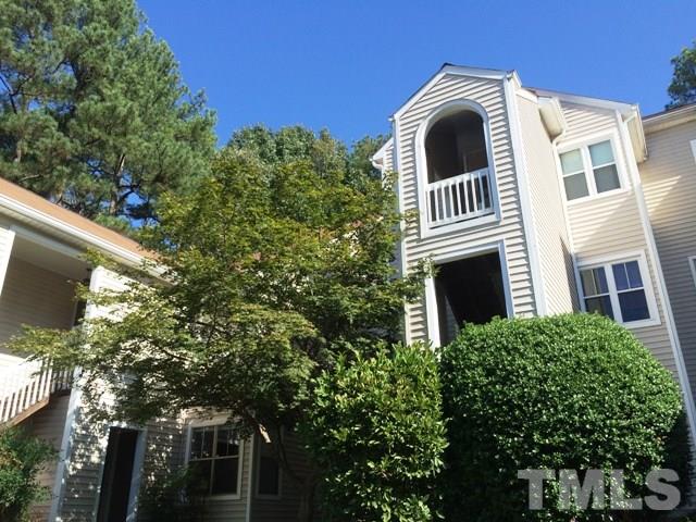6000 Winterpointe Lane, Unit 303 Raleigh, NC 27606 - Photo 1 of 15 a view of a white house with a large tree and a yard