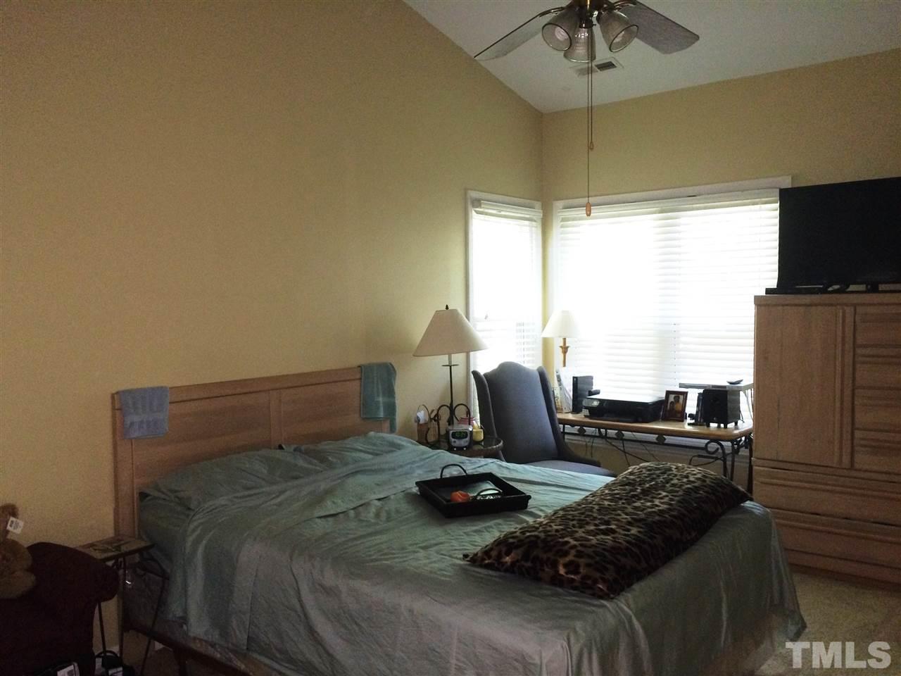 6000 Winterpointe Lane, Unit 303 Raleigh, NC 27606 - Photo 12 of 15 a bedroom with a bed and flat screen tv
