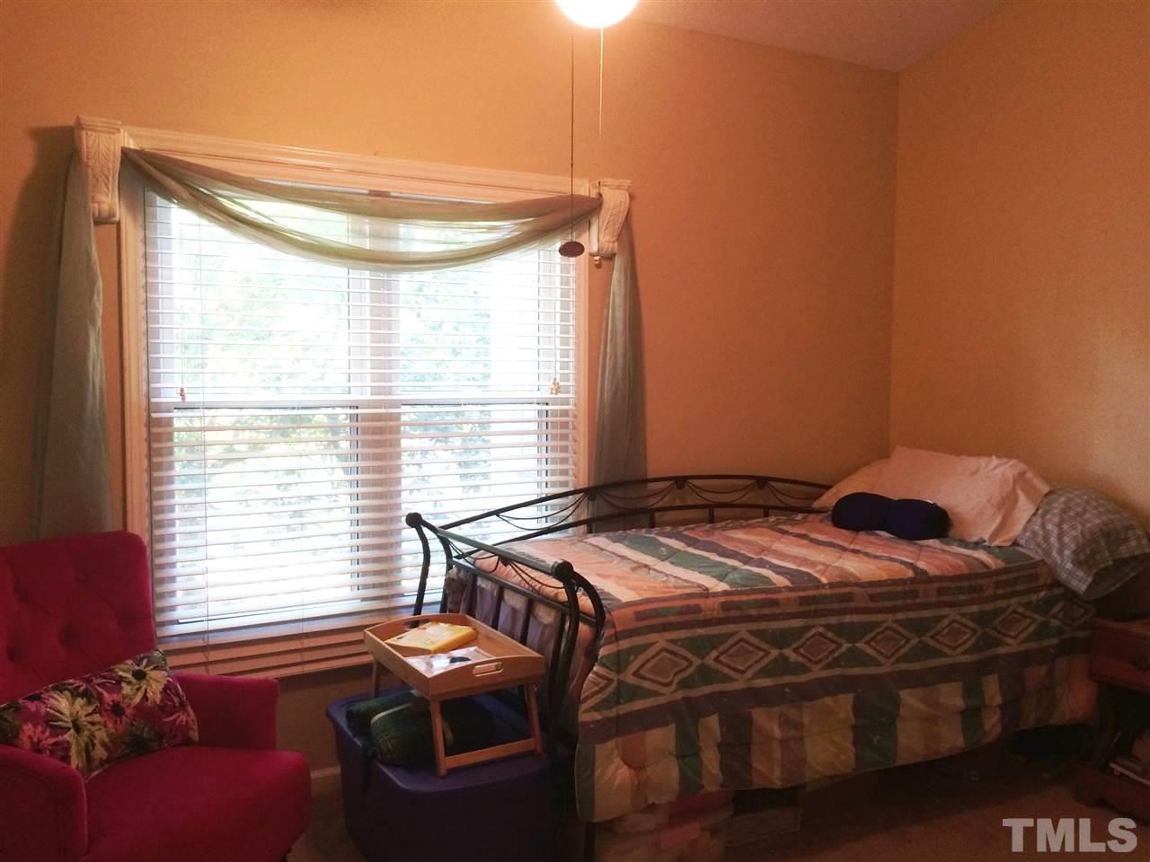 6000 Winterpointe Lane, Unit 303 Raleigh, NC 27606 - Photo 14 of 15 a bedroom with a bed and a window