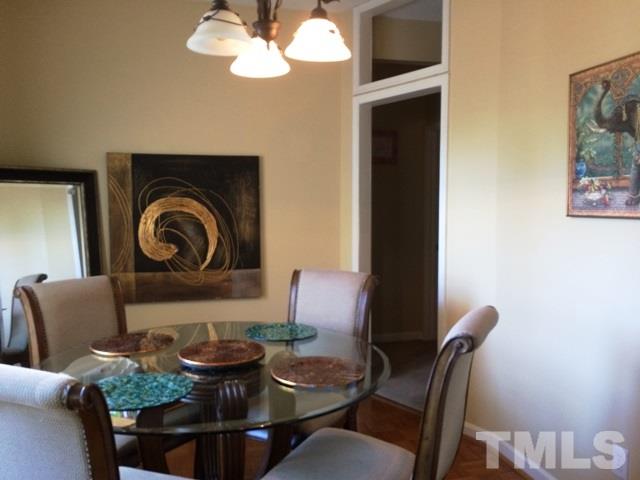 6000 Winterpointe Lane, Unit 303 Raleigh, NC 27606 - Photo 4 of 15 a dining room with furniture and a large window