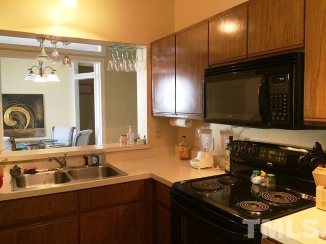 6000 Winterpointe Lane, Unit 303 Raleigh, NC 27606 - Photo 6 of 15 a kitchen with a sink stove and microwave
