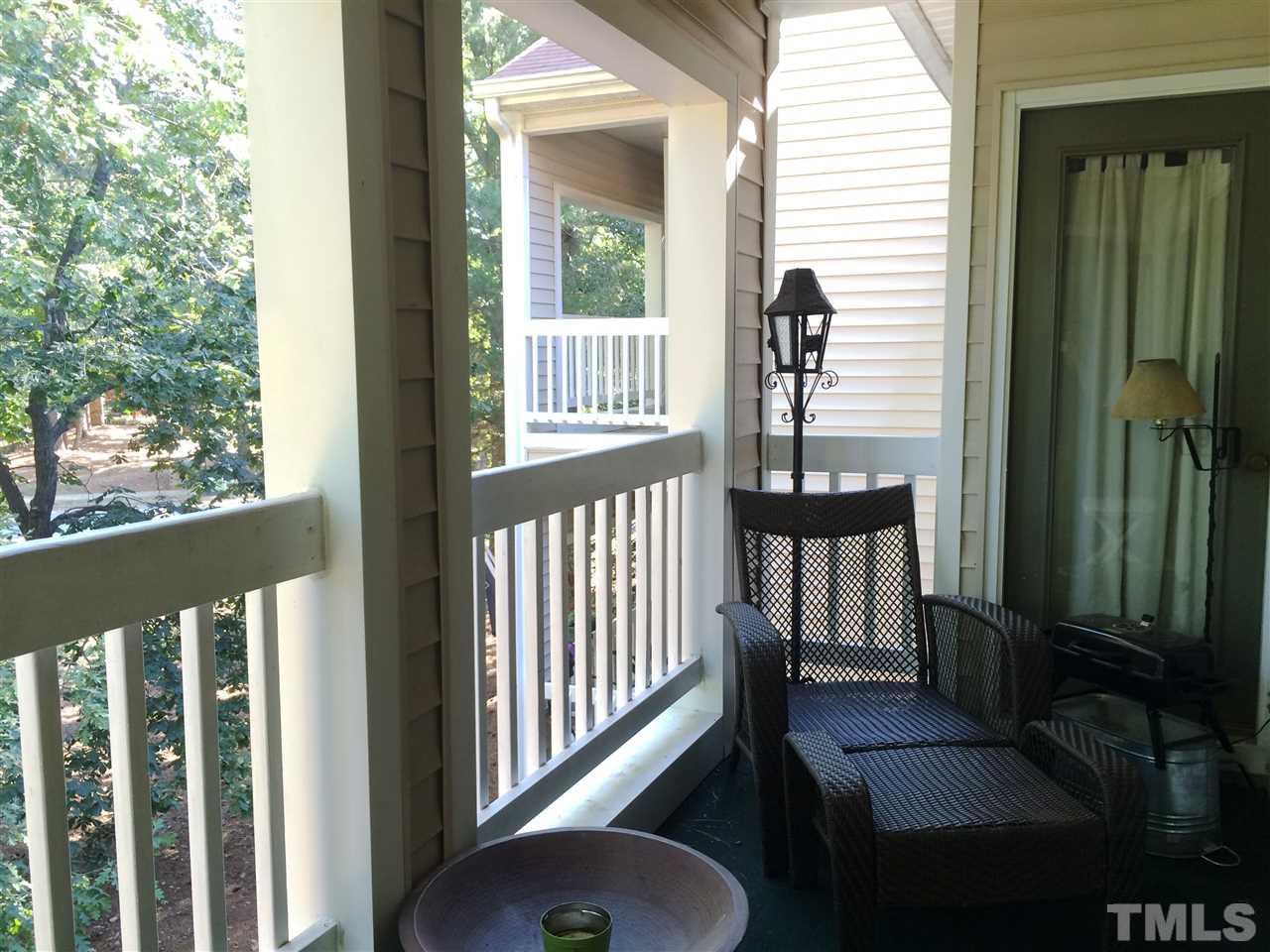 6000 Winterpointe Lane, Unit 303 Raleigh, NC 27606 - Photo 10 of 15 a view of a porch with wooden floor and bench