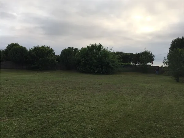 a view of a lake next to a yard