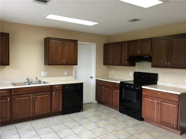 a kitchen with stainless steel appliances granite countertop a stove sink and cabinets