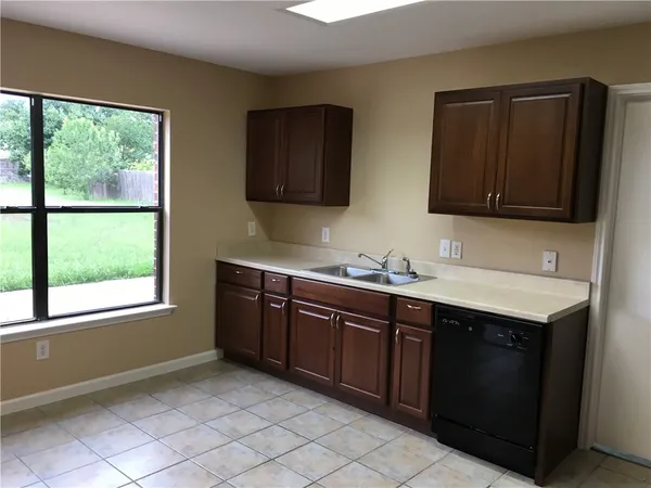 a spacious bathroom with a granite countertop sink and a mirror