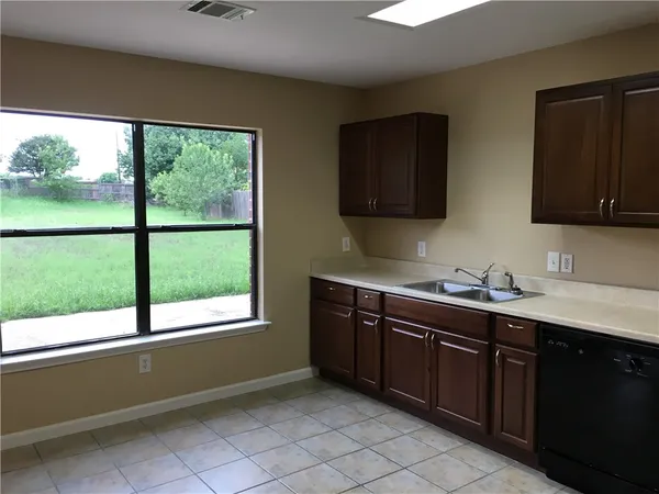 a kitchen with a sink and a window