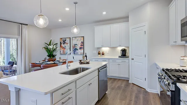 a kitchen with stainless steel appliances a sink stove and refrigerator