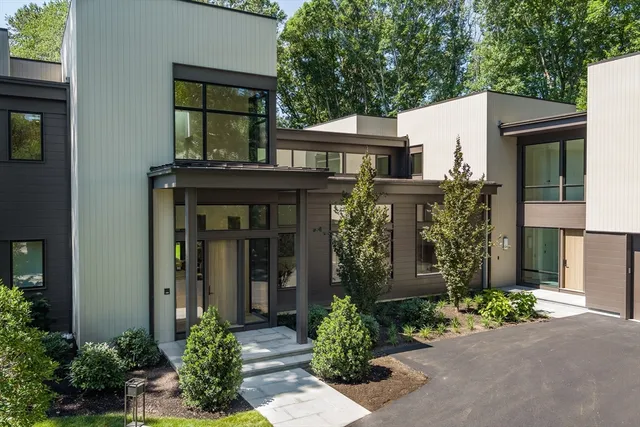 front view of a house with potted plants