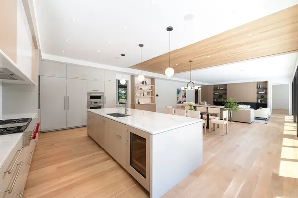 a large white kitchen with a large window