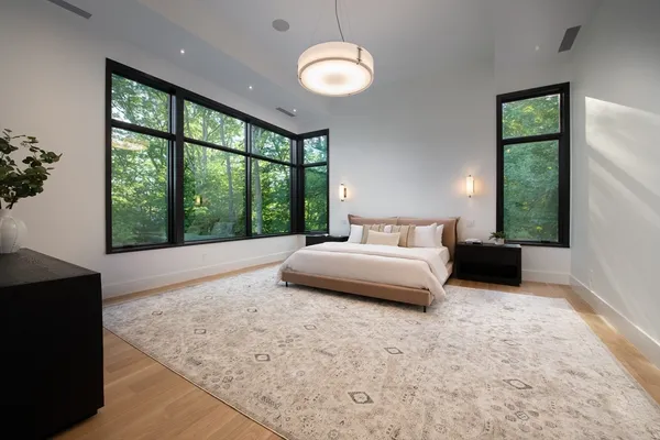 a bedroom with a large bed and a large window