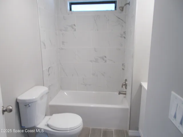 a bathroom with a toilet and a bathtub
