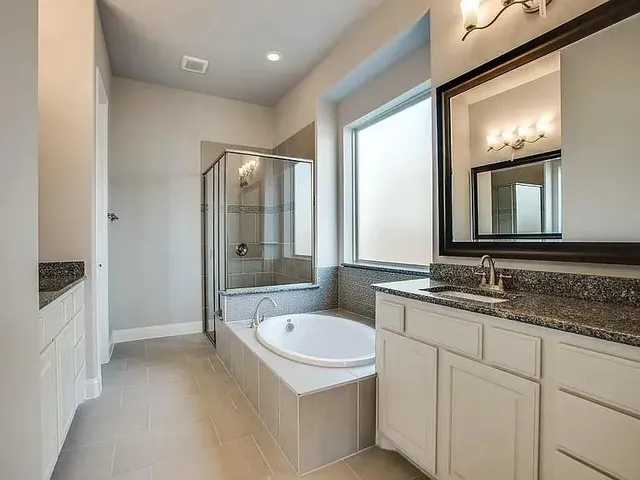 a bathroom with a granite countertop sink mirror and double