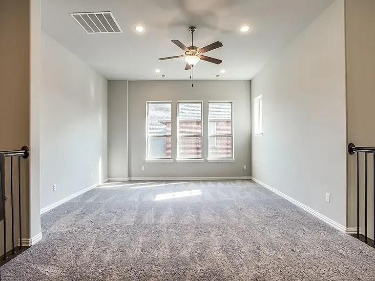 1322 Rolling Thunder Road Frisco, TX 75036 - Photo 15 of 20 an empty room with windows and ceiling fan