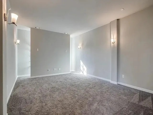 a view of an empty room with a bathroom