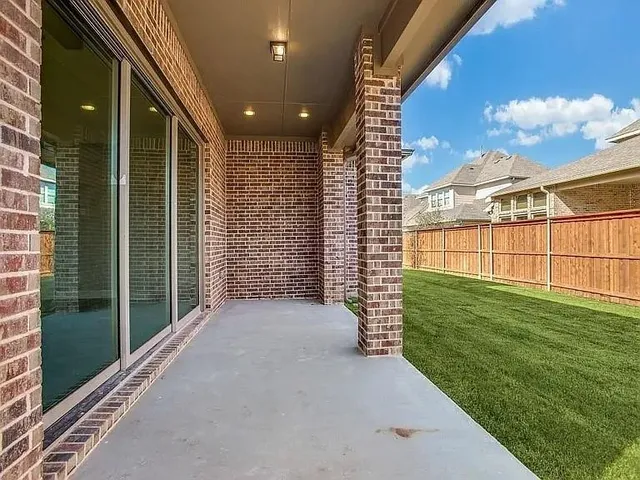 a view of a porch with a big yard and potted plants