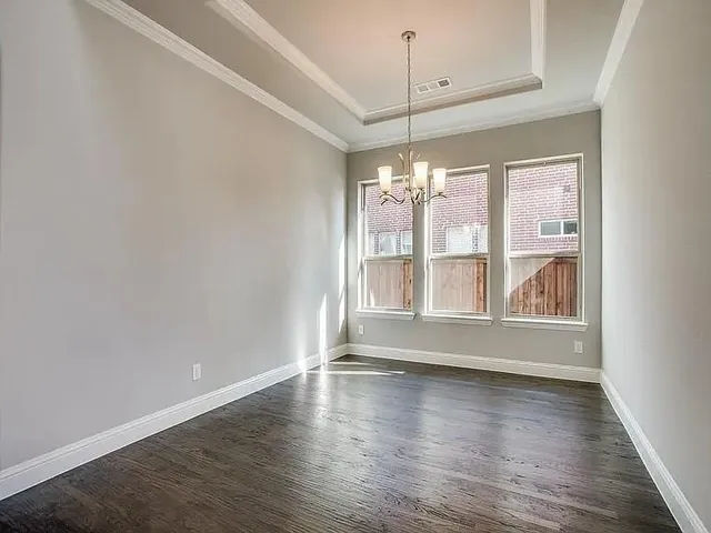 an empty room with wooden floor and door