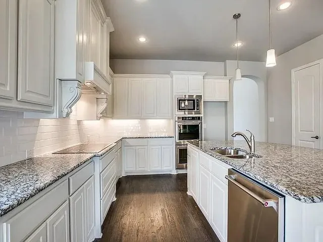 a kitchen with a sink stove and cabinets