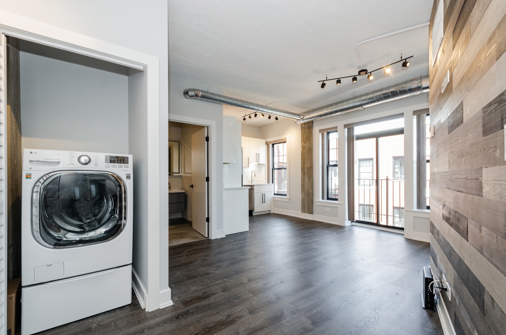 7645 North Sheridan Road, Unit 213 Chicago, IL 60626 - Photo 2 of 14 a view of a hallway with wooden floor and a kitchen