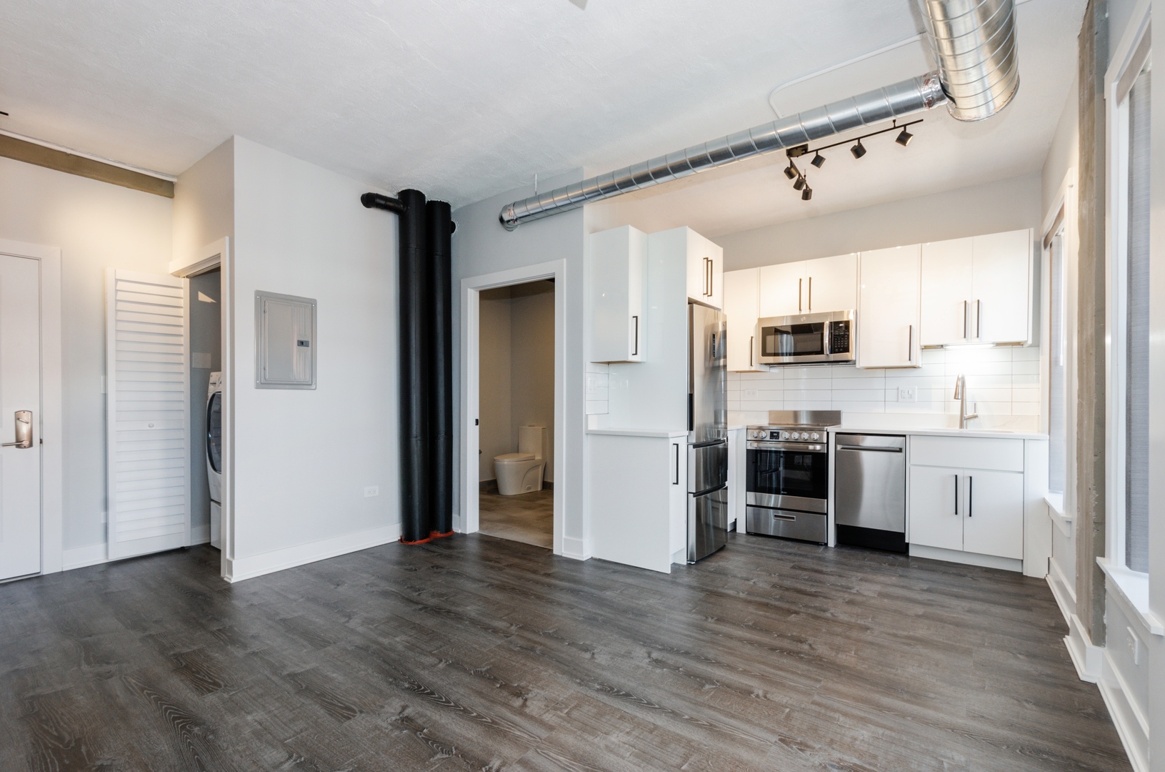 7645 North Sheridan Road, Unit 213 Chicago, IL 60626 - Photo 3 of 14 a kitchen with a refrigerator and a stove top oven