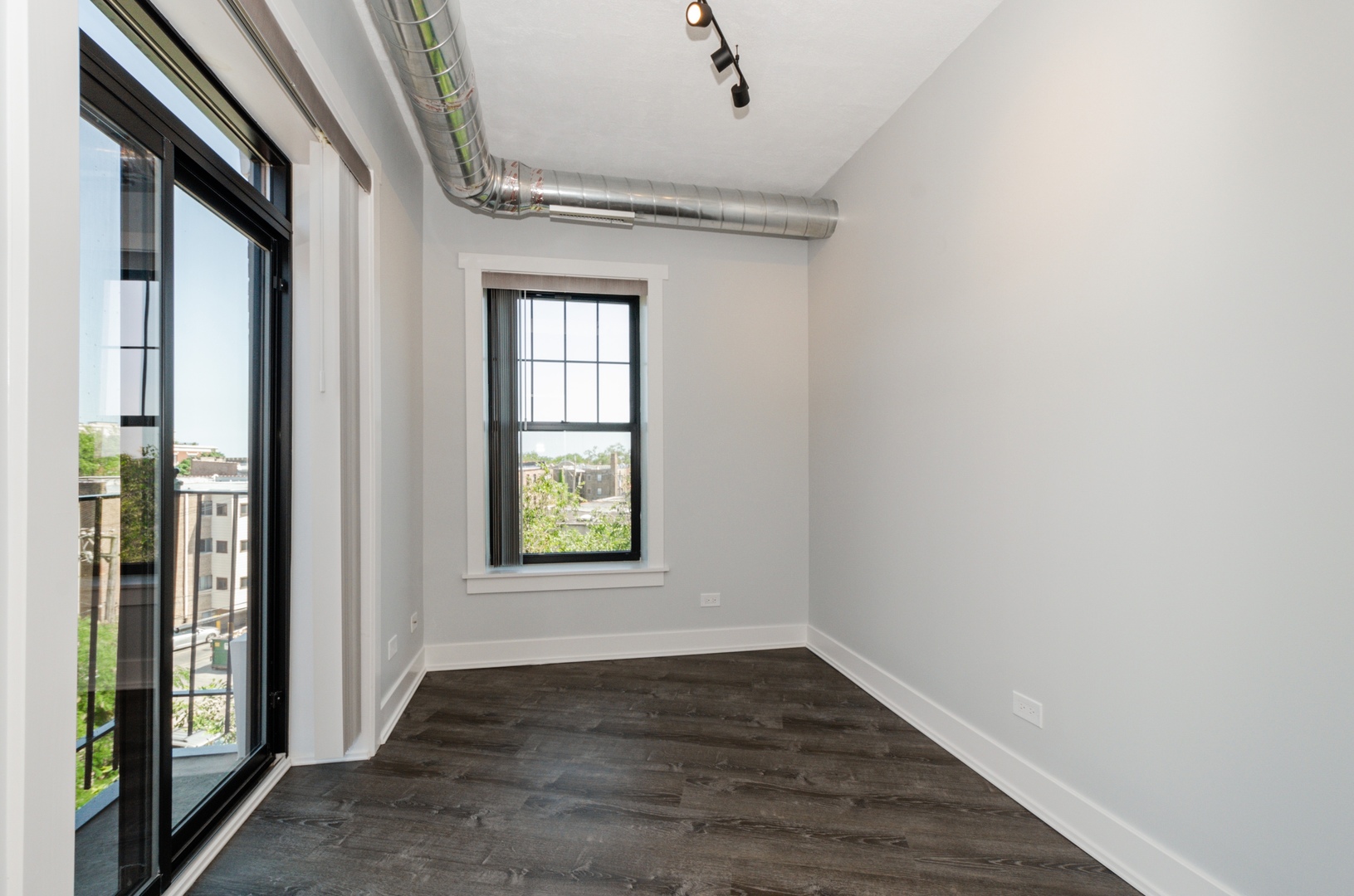 7645 North Sheridan Road, Unit 213 Chicago, IL 60626 - Photo 6 of 14 a view of an empty room with wooden floor and a window