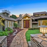 a front view of a house with a garden