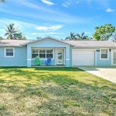 a view of a house with a backyard