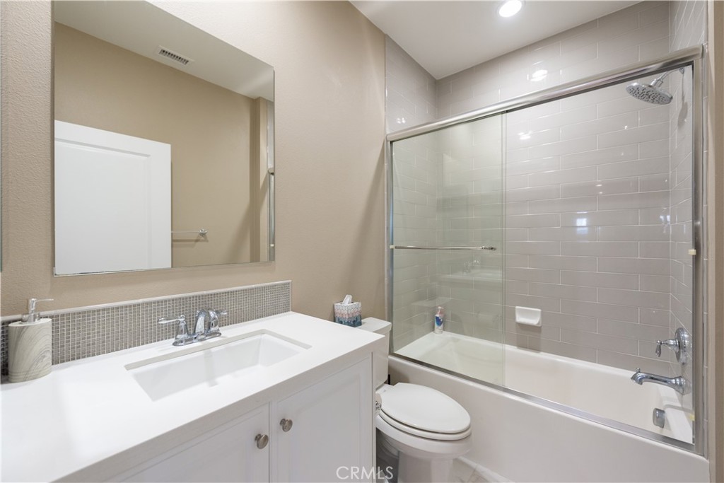 102 Diamondback Irvine, CA 92618 - Photo 21 of 47 a bathroom with a bathtub shower sink vanity mirror and toilet