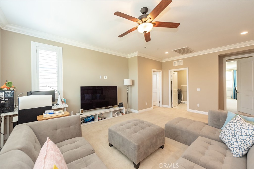 102 Diamondback Irvine, CA 92618 - Photo 25 of 47 a living room with furniture and a flat screen tv