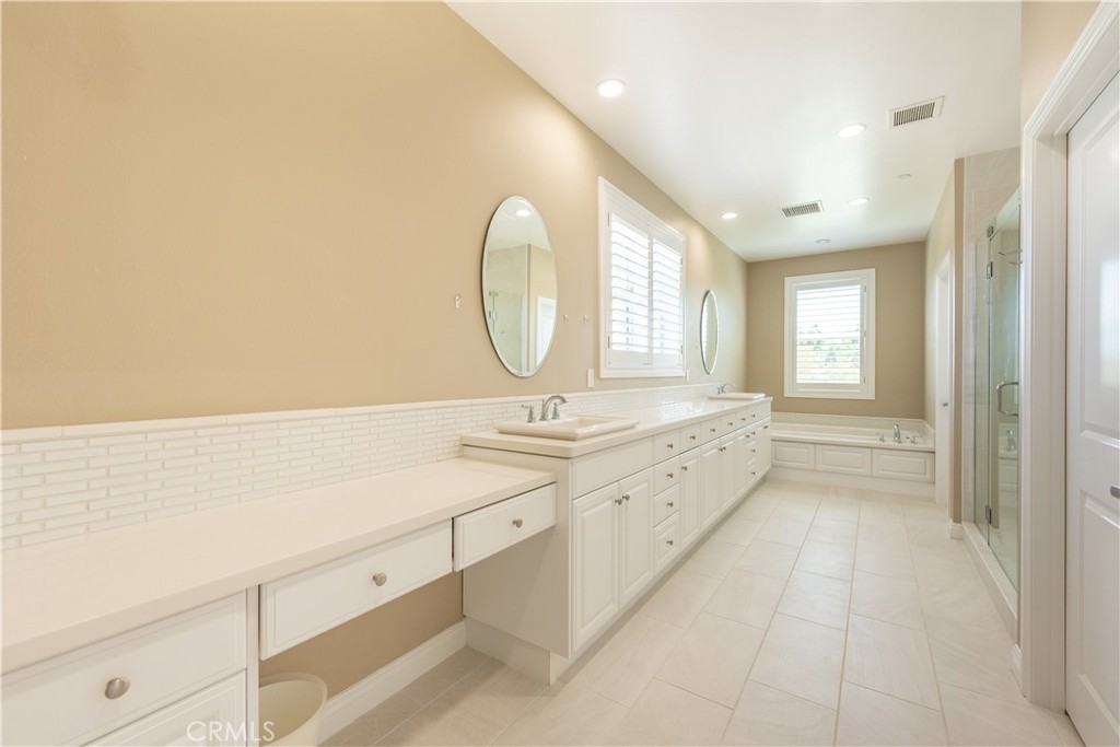 102 Diamondback Irvine, CA 92618 - Photo 33 of 47 a spacious bathroom with a double vanity sink and a mirror
